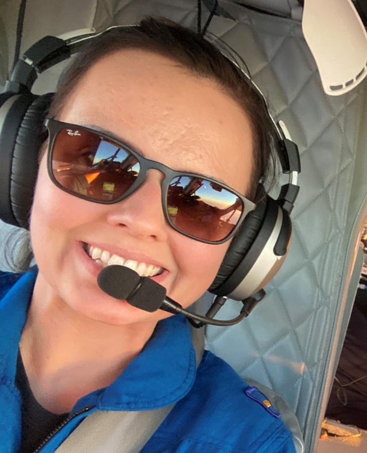 A female NOAA Corps pilot on the flight deck of a Twin Otter aircraft