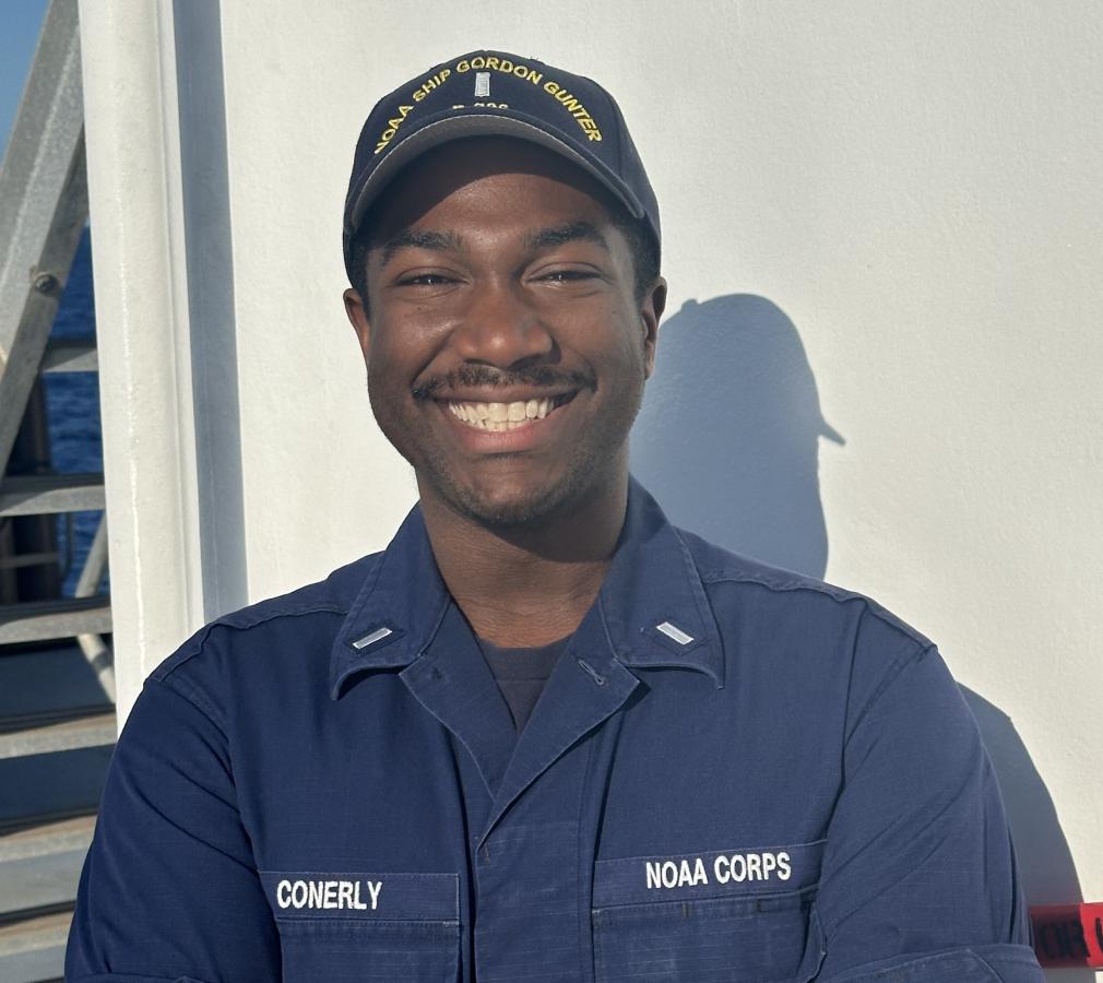 A male NOAA Corps officer on the deck of a NOAA ship