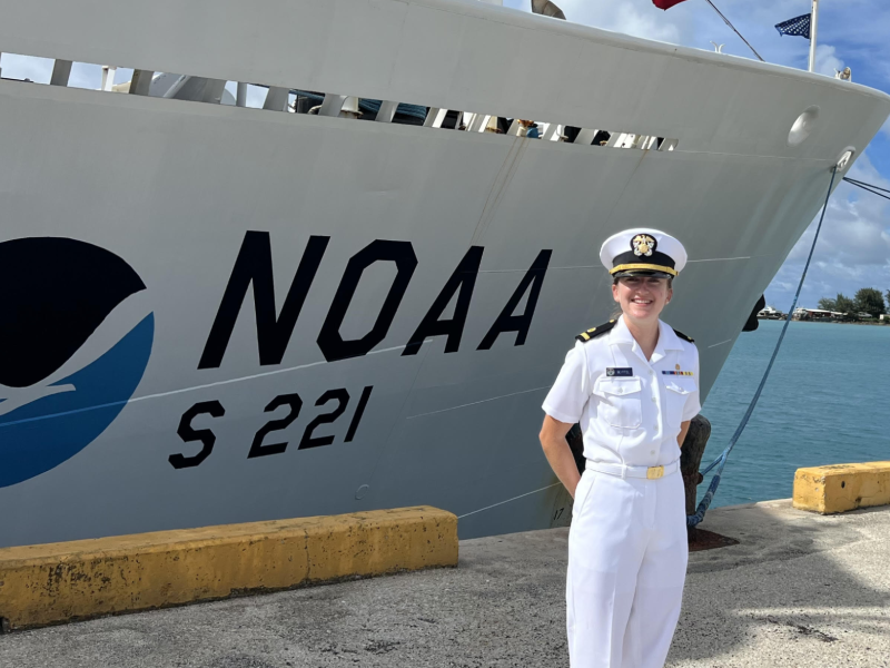 A NOAA Corps officer standing in front of NOAA Ship Rainier