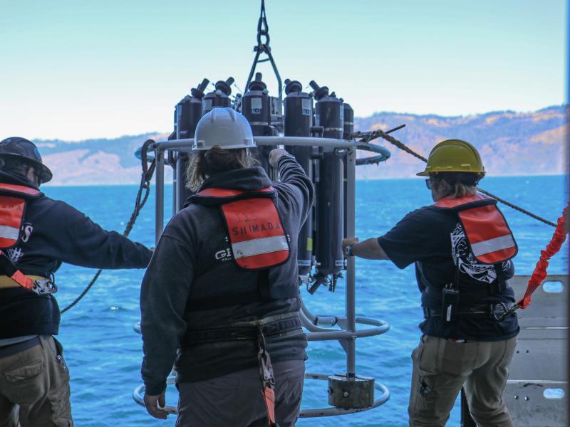 NOAA ship crew with an oceanographic instrument