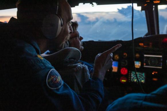 Pilots on the flight deck of a NOAA WP-3D Orion hurricane hunter aircraft