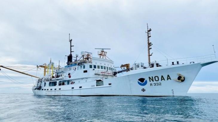 A white NOAA ship on the ocean