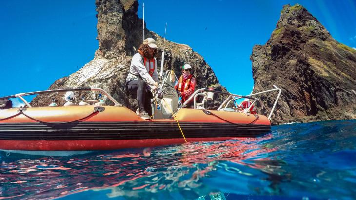 A diver beneath a NOAA small boat 