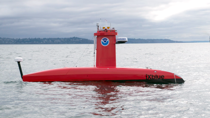 A bright orange uncrewed surface vessel floating on the water