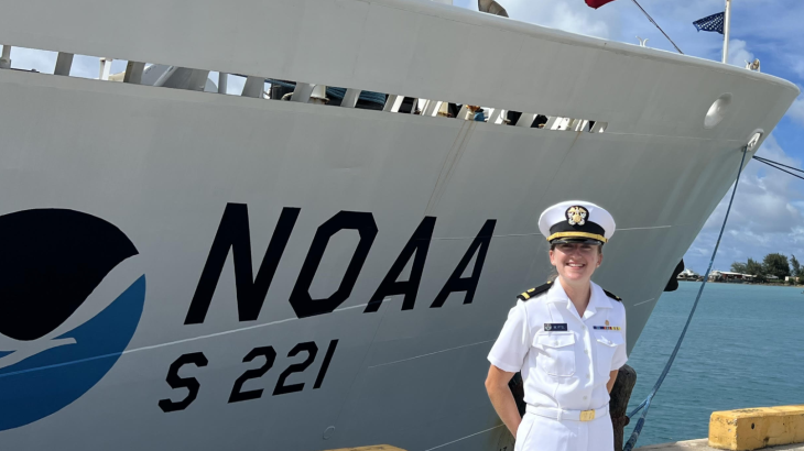 A NOAA Corps officer standing in front of NOAA Ship Rainier