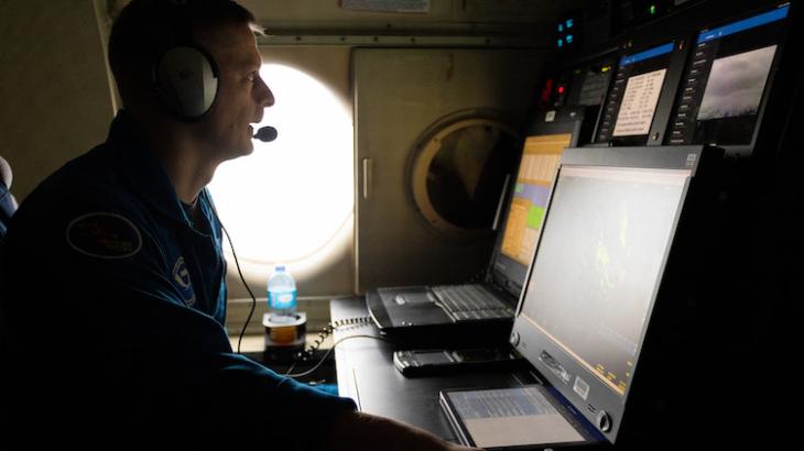 Flight Director sits at workstation in aircraft