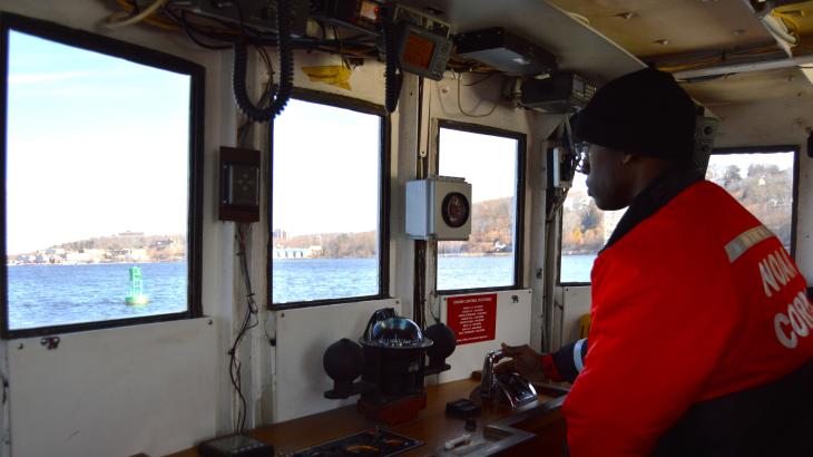 NOAA Corps officer candidate, Edward Harris, practicing station keeping on the Thames river on United States Coast Guard Academy training boat.