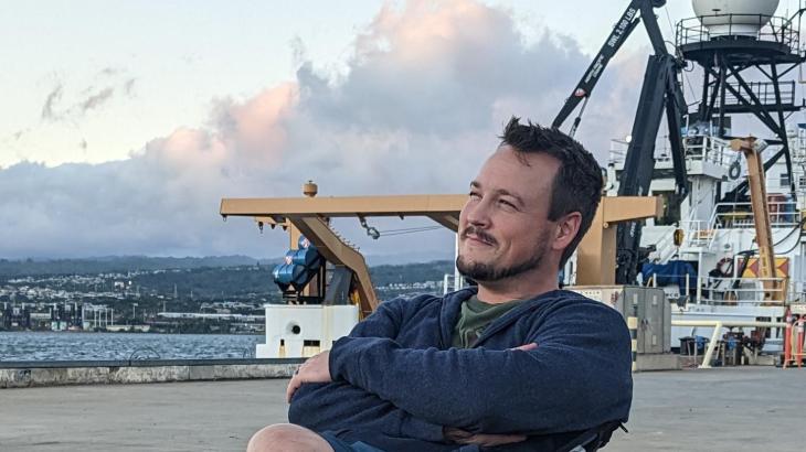 Mariner Jason Dlugos enjoying the sunset on the dock in front of NOAA Ship Oscar Elton Sette.