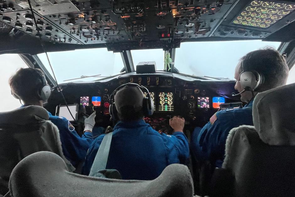 Pilots and flight engineer at the controls of NOAA WP-3D Orion N42RF during flight into Hurricane Ian