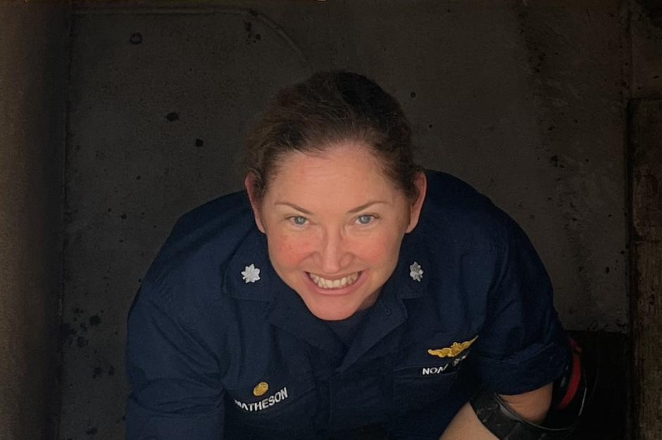 A female NOAA Corps officer in a stairwell aboard a ship