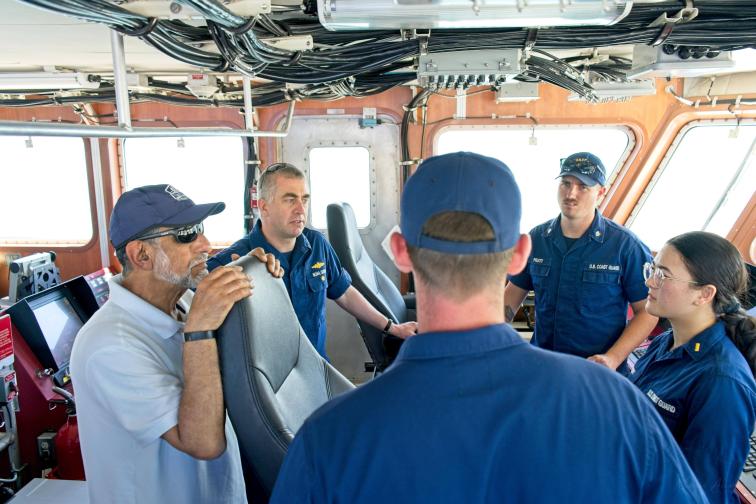 RDML Evans (second from left) talks with navigation partners. 