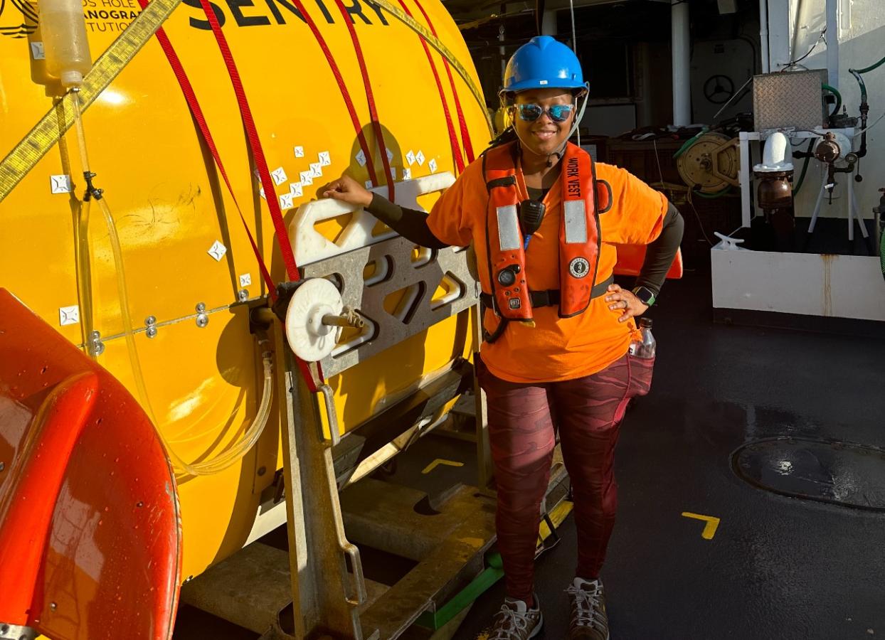 A crew member standing on the deck of a NOAA ship