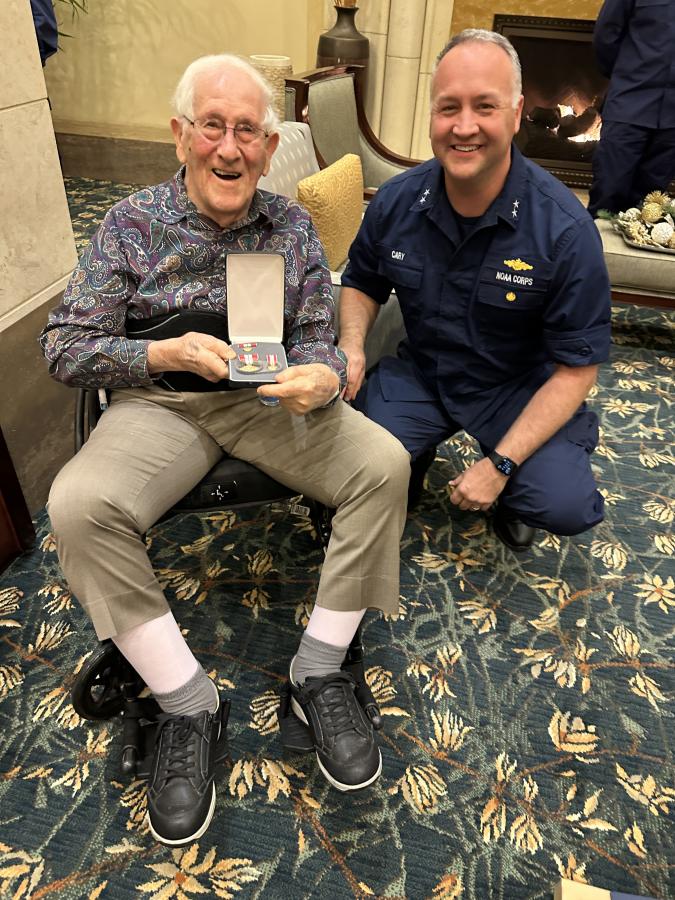 CAPT (ret.) Sam Baker with his award from RADM Chad Cary