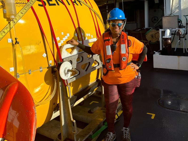 A crew member standing on the deck of a NOAA ship