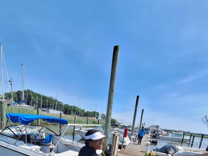 Knauss Fellow, Chesna Cox, wheels a glider on a cart down a dock.