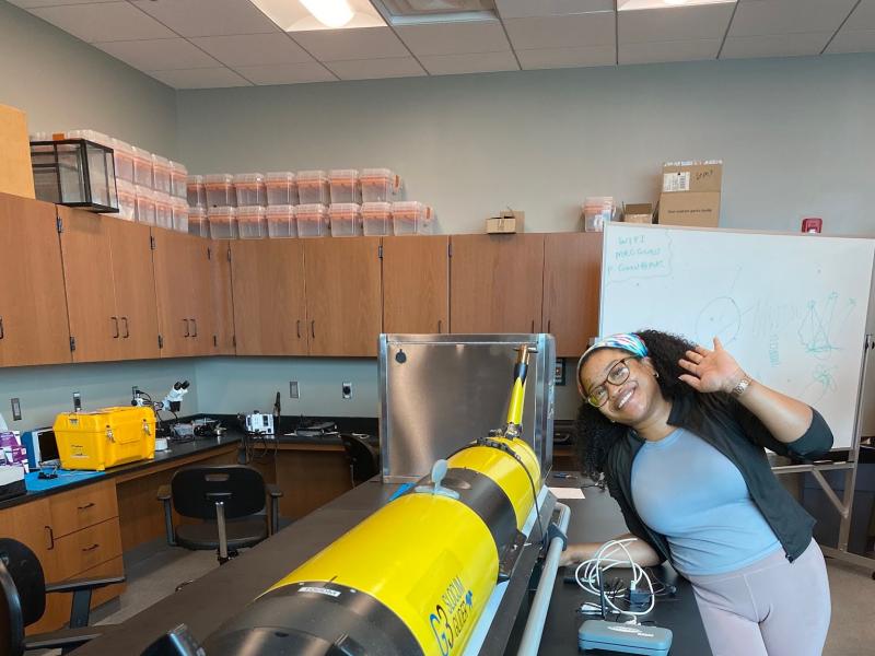 OMAO Knauss Fellow, Chesna Cox, with a yellow underwater buoyancy glider.