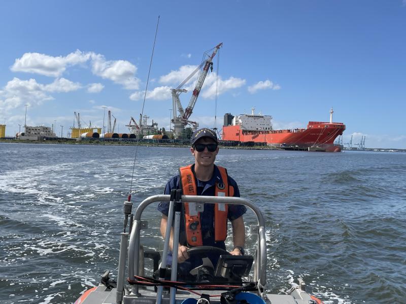 LTJG Tim Montera driving a small boat.