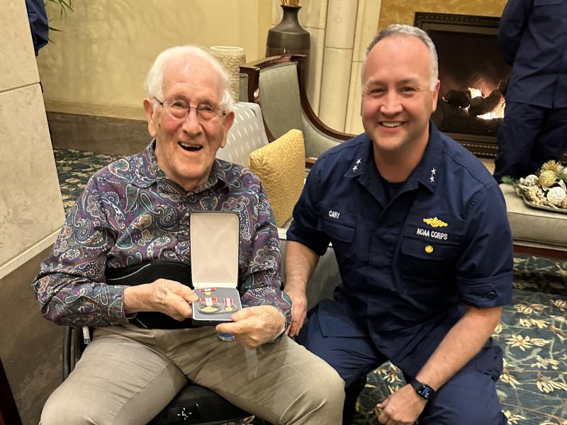 CAPT (ret.) Sam Baker with his award from RADM Chad Cary