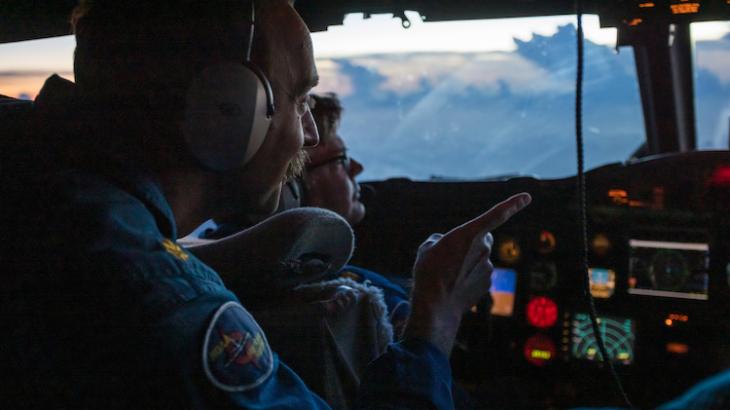 Pilots on the flight deck of a NOAA WP-3D Orion hurricane hunter aircraft