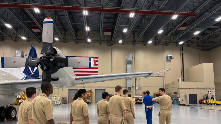 Lt. Eric Fritzsche leads new NOAA Commissioned Officer Corps pilots on a tour of the NOAA Aircraft Operations Center hangar.