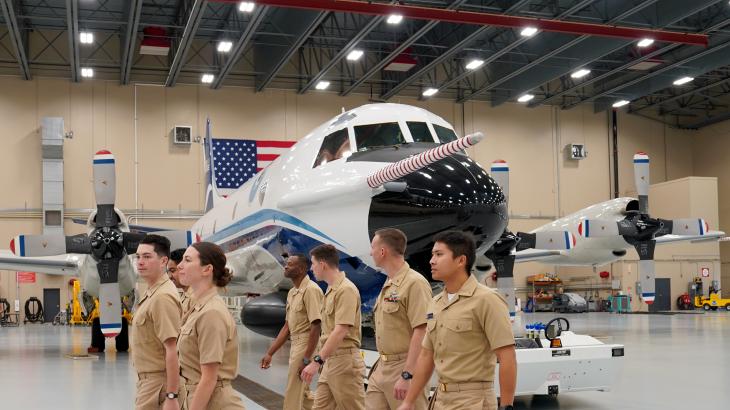 NOAA Commissioned Officer Corps pilots walk through the hangar during their tour of the NOAA Aircraft Operations Center in Lakeland, Fla.