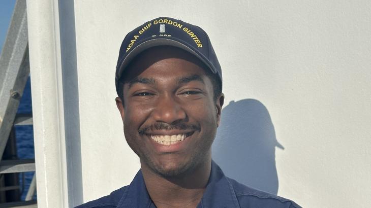 A male NOAA Corps officer on the deck of a NOAA ship