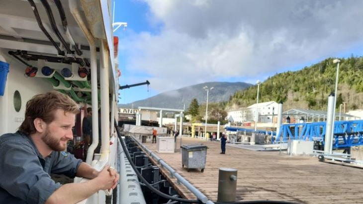 Sean Battles looks out from NOAA Ship Fairweather watching dockside activities.