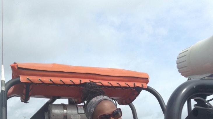 Leslie Allen driving a small boat from NOAA Ship Ronald H. Brown. Photo: NOAA/Michael Lastinger