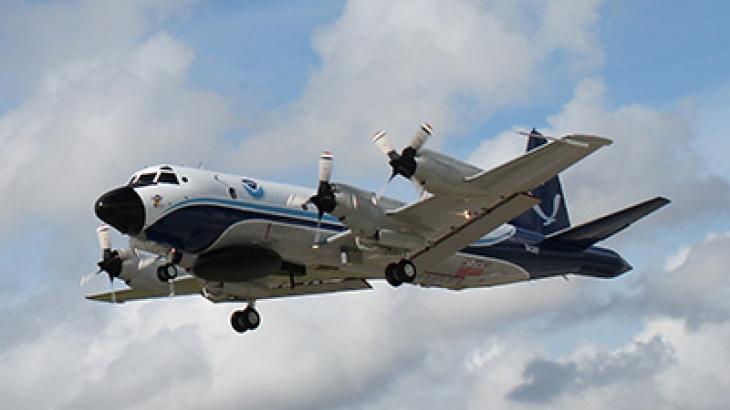 Four-engine propeller plane in the air