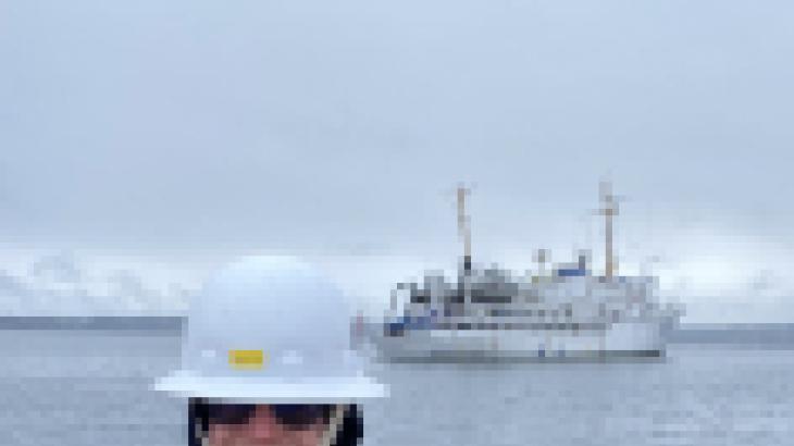 Garret Mayer with NOAA Ship Fairweather in the background. 