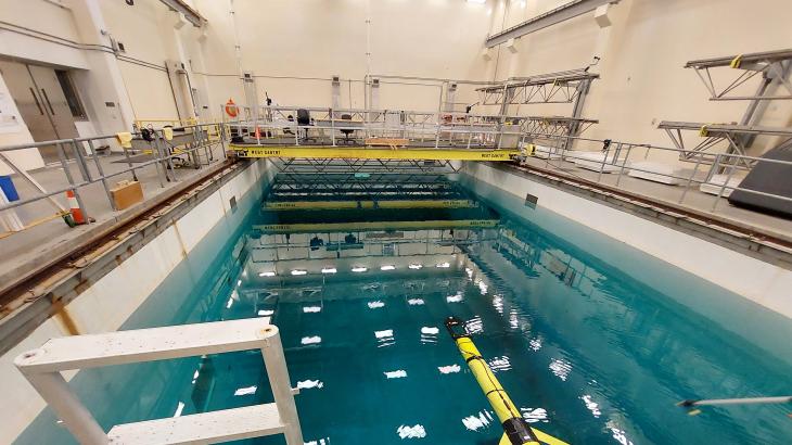 A yellow Slocum glider in an Olympic swimming pool-sized test tank.