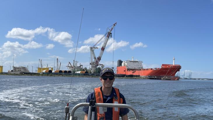 LTJG Tim Montera driving a small boat.