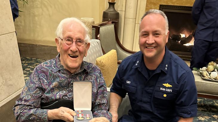 CAPT (ret.) Sam Baker with his award from RADM Chad Cary