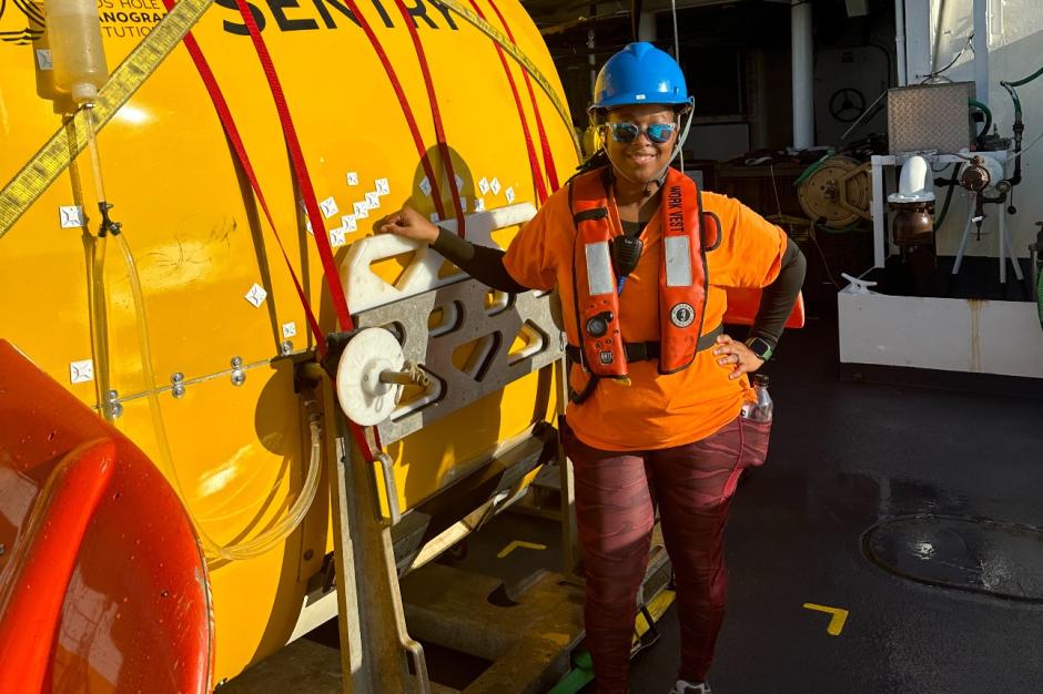 A crew member standing on the deck of a NOAA ship