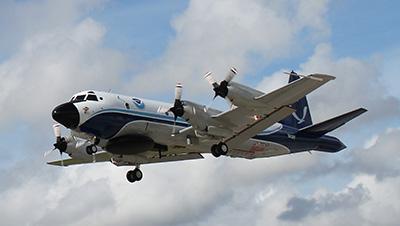 Four-engine propeller plane in the air