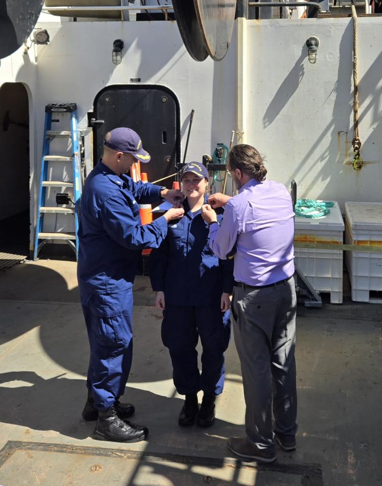 Rear Adm. Amanda Goeller receiving her new pins during her promotion ceremony aboard NOAA Ship Bell M. Shimada